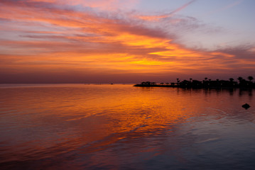 Red sunrise on ocean. Morning early morning under sea. Sunrise