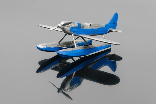 Blue plastic aquaplane on the grey mirror background