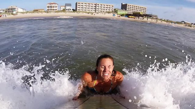 Girl Paddling Through Surf