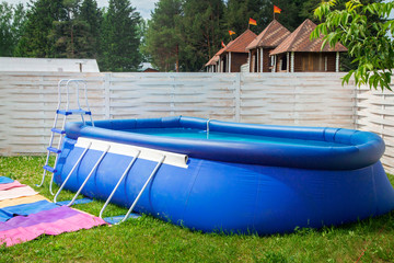Blue inflatable pool among garden