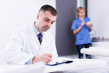 Obraz premium Cosmetician working with papers