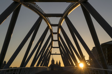 Fototapeta premium Modern bridge over canal at sunset in Amsterdam