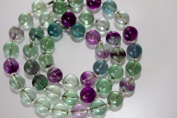 close up macro natural fluorite gem beads isolated on white background
