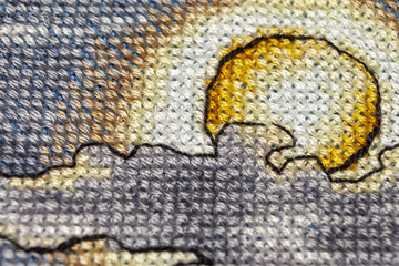 Cross-stitch. Macro photography of embroidery sites. Shooting with a small bluff of sharpness.