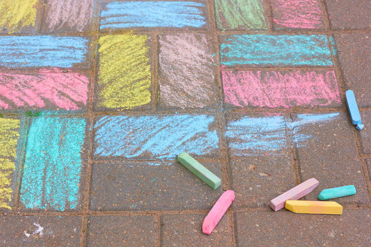 Drawing chalk on the asphalt.