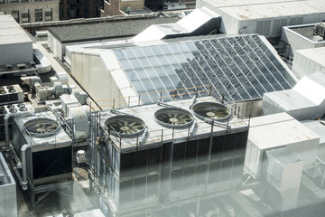 industrial, rooftop of building with ac cooling unites and glass skylights