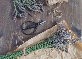 Lavender harvesting Lavender bouquet on dark wooden background Aromatherapy concept Traditional medicine Top view Copy space Vintage French Provence style