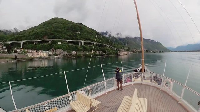 Tourist ship sails along the Lake Geneva to the Chillon Castle.