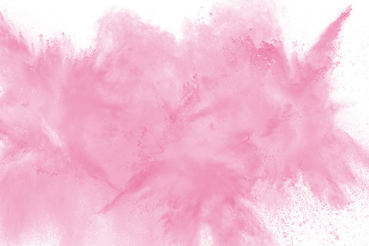 Abstract pink powder explosion on white background. Freeze motion of pink dust splash.