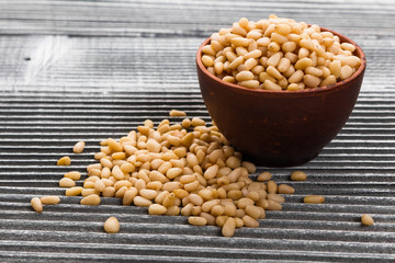 peeled pine nuts on a rustic background