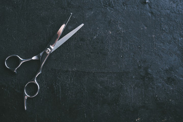 Hairdresser scissors on black background