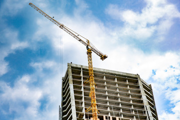 Fototapeta na wymiar Skyscraper construction. Tower crane over construction building.