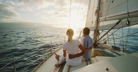 Retired middle aged couple sailing into the sunset - Powered by Adobe