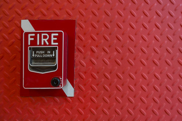 Fire alarm hand lever red on red diamond steel background wall