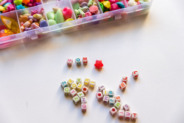 Many Different Beads and Jewelry Isolated on White Background