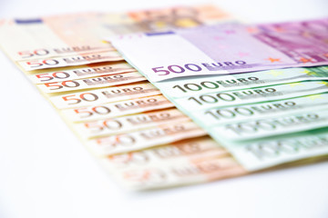 Euro banknotes close up. Several hundred euro banknotes on white background