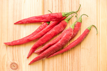 red hot chilly peppers on wooden table