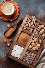 Coffee cup and various sugar