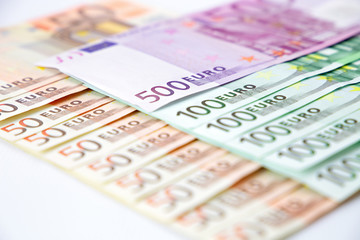Euro banknotes close up. Several hundred euro banknotes on white background