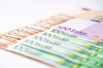 Euro banknotes close up. Several hundred euro banknotes on white background