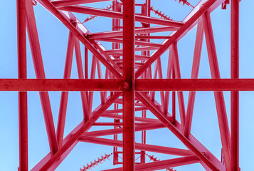 High-voltage power lines, bottom view. Red electricity distribution station .