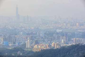 Aerial view of Taipei 101 tower in XinYi District, and Keelung River, capital city of Taiwan, with heavily polluted air on a hazy winter day ~ Air pollution level of PM2.5 classified as 