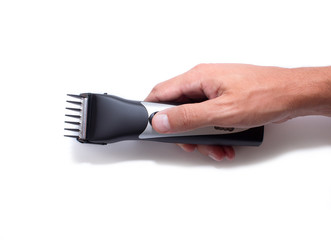 Fototapeta na wymiar A hairstyle machine. Barbershop. Hair clipper in hand isolated on white background
