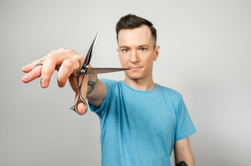 Barber holds scissors, isolated on a white background.
