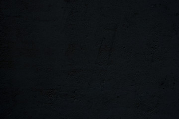 dark black textured stucco cement wall surface