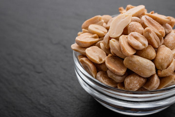 fresh peanuts on a dark stone background