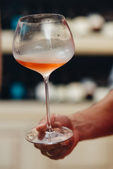 a luxurious glass of rose wine in a man's hand sommelier