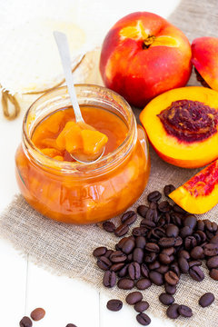 Nectarine jam confiture in ramekin and jar. Dark background. Selective focus. Close up.