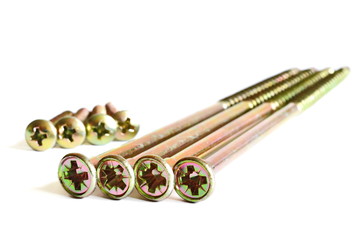 Set of four long and four short yellow tapping screws on a white background. Isolated