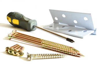 Set of long, medium and short yellow tapping screws, tip of the Phillips screwdriver with rubbery...