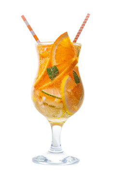 glass with straw of homemade lemonade with sliced fresh lemon, orange, lime, twig mint and bubble over white background, close up