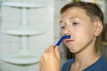 A little boy tries to shave and does not know how