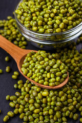 fresh Mung beans on a dark stone background
