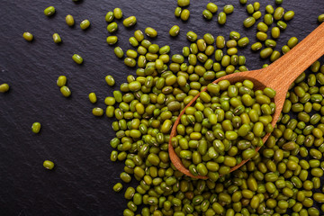 fresh Mung beans on a dark stone background