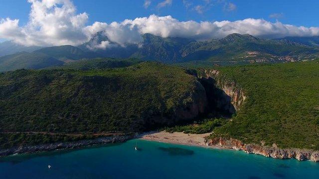Summer Ionian Sea Aerial. coastline view with sandy beach on the sunset with green bushes in front, Albania dhermi gjipe beach.