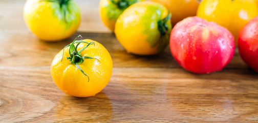 Yellow And Red Tomatoes On A Wooden Table