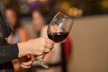 Woman holding a glass of red wine