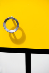 The facade of the kitchen cabinet with a handle made of laminated chipboard. Bright surface of the cabinet door.