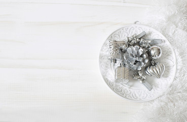 Set of Christmas silver ornaments on white wood background