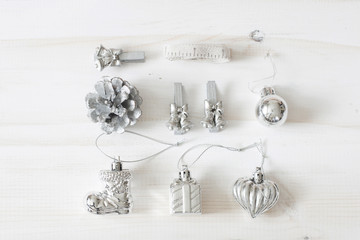 Set of Christmas silver ornaments on white wood background