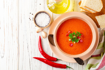 Gazpacho soup in bowl on white wooden background. Traditional spanish dish.