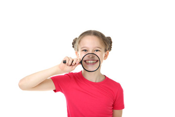 Cute young girl with magnifying glass on white background