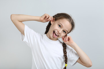 Happy young girl on grey background