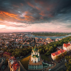 Panorama of the city of Kiev with the domes of St. Andrew's Church in the foreground, the historic district of Podol and the Dnieper River in the background. Cityscape