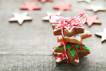 Christmas gingerbread cookies on grey wooden table