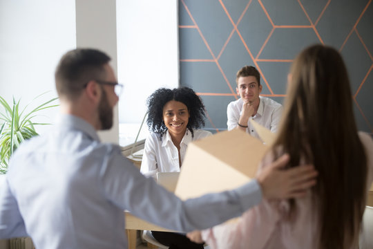 Excited multiracial colleagues welcoming newcomer in office, male boss introducing new employee at coworking space, get acquainted with diverse coworkers, newbie on first working day, introduction